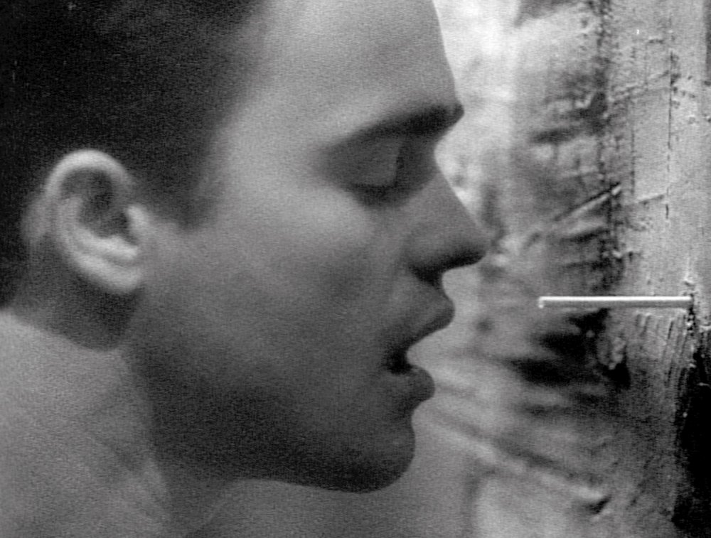 chant-d-amour-002-man-inhaling-smoke-through-wall