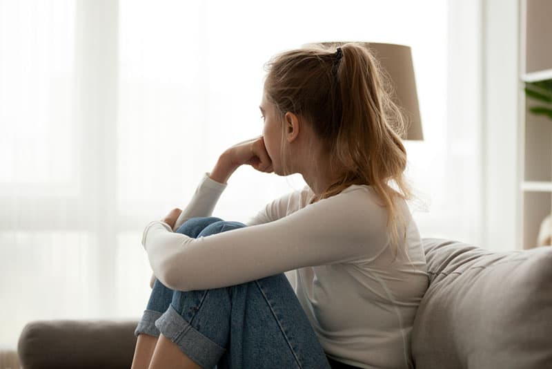 thoughtful-woman-sitting-at-home